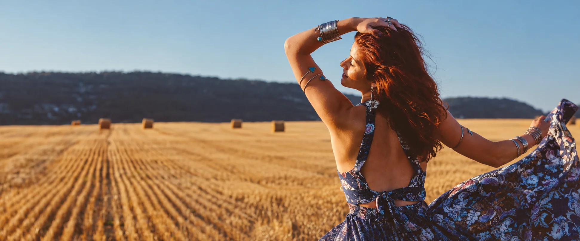Woman in a sunlit autumn harvest field